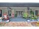 Inviting front porch with rocking chairs and lush landscaping at 180 Robinson Ln, Seville, FL 32190
