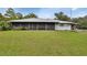 House exterior with screened porch and metal roof at 180 Robinson Ln, Seville, FL 32190