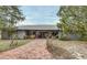 Ranch-style home with metal roof and brick walkway at 180 Robinson Ln, Seville, FL 32190