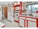 Kitchen features red and white cabinets, microwave, oven, and refrigerator at 180 Robinson Ln, Seville, FL 32190
