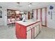 Spacious kitchen with red and white cabinetry, an island, and a breakfast nook at 180 Robinson Ln, Seville, FL 32190
