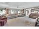 Open living room with multiple seating areas and lake view at 180 Robinson Ln, Seville, FL 32190