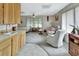 Cozy living room with a kitchenette, sofa, and armchair at 180 Robinson Ln, Seville, FL 32190