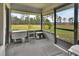 Screened porch with tranquil views and rocking chairs at 180 Robinson Ln, Seville, FL 32190