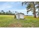 Small, white storage shed in grassy backyard at 180 Robinson Ln, Seville, FL 32190