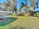 Large backyard with grassy lawn and shaded areas at 2129 Lime Tree Dr, Edgewater, FL 32141