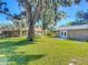 Spacious backyard with large tree and shed at 2129 Lime Tree Dr, Edgewater, FL 32141