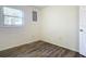 Well-lit bedroom with wood-look floors and a window at 2129 Lime Tree Dr, Edgewater, FL 32141