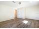 Well-lit bedroom featuring wood-look floors and double-door closet at 2129 Lime Tree Dr, Edgewater, FL 32141