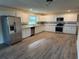Bright kitchen with white cabinets, granite counters, and stainless steel appliances at 2129 Lime Tree Dr, Edgewater, FL 32141