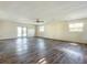 Spacious living room with wood-look floors and access to a patio at 2129 Lime Tree Dr, Edgewater, FL 32141