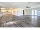 Open living room showcasing wood-look floors and views of the kitchen at 2129 Lime Tree Dr, Edgewater, FL 32141