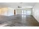 Large living area with wood-look floors and sliding glass doors at 2129 Lime Tree Dr, Edgewater, FL 32141