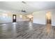 Open concept living room with wood-like flooring and kitchen access at 2129 Lime Tree Dr, Edgewater, FL 32141