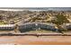 Aerial view of beachfront building, pool, and surrounding neighborhood at 2700 Ocean Shore Blvd # 317, Ormond Beach, FL 32176