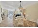 A dining and living room with wood-style tile, a chandelier, and access to a balcony at 2800 N Atlantic Ave # 212, Daytona Beach, FL 32118