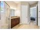 Bright bathroom featuring a glass shower, granite countertop vanity, and tile flooring leading to the bedroom at 430 Cypress Hills Way, Deland, FL 32724