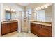 A luxurious bathroom features dual vanities, granite countertops, and a glass-enclosed shower for a spa-like feel at 430 Cypress Hills Way, Deland, FL 32724