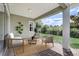Staged covered patio with brick pavers and furniture, perfect for enjoying the view of the green landscape at 430 Cypress Hills Way, Deland, FL 32724