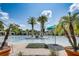 Community pool area with a large pool, palm trees, lounge chairs, and a bright blue sky at 430 Cypress Hills Way, Deland, FL 32724