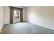 Empty bedroom with carpeted floors and a window at 4928 Fells Cove Ave, Kissimmee, FL 34744