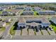 Aerial view of townhomes featuring attached garages, and paved driveways, set in a well-maintained community at 635 Belgrove St, Debary, FL 32713