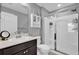 Modern bathroom featuring a glass-enclosed shower, vanity with storage, and a decorative cabinet at 635 Belgrove St, Debary, FL 32713
