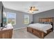 Comfortable bedroom featuring two windows, a ceiling fan, and neutral gray walls at 635 Belgrove St, Debary, FL 32713