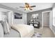 Well-lit bedroom featuring a comfortable bed, accent furniture, and convenient ensuite access at 635 Belgrove St, Debary, FL 32713