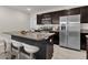 Modern kitchen with granite countertops, stainless appliances, and a breakfast bar with seating at 635 Belgrove St, Debary, FL 32713