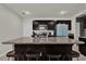 Kitchen island with granite countertop and seating, stainless sink and appliances, and dark wood cabinets at 635 Belgrove St, Debary, FL 32713