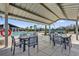 Outdoor community pool with a covered seating area, tables, chairs, and a lifeguard float for resident's enjoyment at 635 Belgrove St, Debary, FL 32713