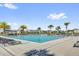 A large rectangular pool with lounge chairs and palm trees create a resort-like atmosphere for relaxation at 635 Belgrove St, Debary, FL 32713