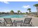 Relaxing poolside seating with lounge chairs, complemented by palm trees and clear views, offer a perfect escape at 635 Belgrove St, Debary, FL 32713