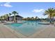 Large community pool, surrounded by swaying palms and lounge chairs, offers a serene and tropical recreational space at 635 Belgrove St, Debary, FL 32713