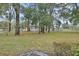 Expansive backyard with mature trees and a white fence offering privacy at 955 N Ridgewood Ave, Deland, FL 32720