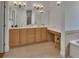 Bathroom features a double vanity, bright lighting, and a separate tub and shower area at 955 N Ridgewood Ave, Deland, FL 32720