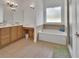 Bathroom featuring a soaking tub, shower, and a vanity area with a makeup table at 955 N Ridgewood Ave, Deland, FL 32720