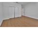 Bright bedroom with hardwood floors and closet with bi-fold doors at 955 N Ridgewood Ave, Deland, FL 32720