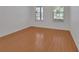 Bedroom with two windows offering natural light and hardwood flooring at 955 N Ridgewood Ave, Deland, FL 32720