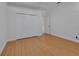 Bright bedroom with hardwood floors and closet with bi-fold doors at 955 N Ridgewood Ave, Deland, FL 32720