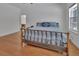 Bedroom with wooden floors and a large window providing natural light at 955 N Ridgewood Ave, Deland, FL 32720