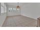Dining room with light fixture and multiple windows with shutters at 955 N Ridgewood Ave, Deland, FL 32720