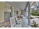Spacious front porch with rocking chairs provides an inviting outdoor living space at 955 N Ridgewood Ave, Deland, FL 32720