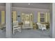 Inviting front porch with rocking chairs and decorative details offer charming curb appeal at 955 N Ridgewood Ave, Deland, FL 32720