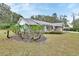 Well-landscaped yard with a charming home featuring stone accents and an American flag at 955 N Ridgewood Ave, Deland, FL 32720