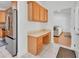 Convenient kitchen area features built-in desk, stainless steel fridge, and modern lighting at 955 N Ridgewood Ave, Deland, FL 32720