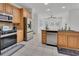 Updated kitchen featuring stainless steel appliances, granite countertops, and tile flooring at 955 N Ridgewood Ave, Deland, FL 32720