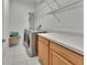 Well-organized laundry room with cabinets, shelving, washer, and dryer at 955 N Ridgewood Ave, Deland, FL 32720