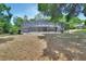 Backyard view of screened-in pool area and mature landscaping at 955 N Ridgewood Ave, Deland, FL 32720